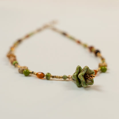 Kralenketting met denvormige hoofdkraal en tijgeroog