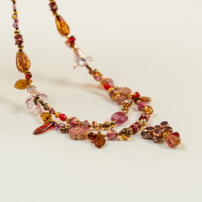 Dubbele kralenketting met fuchsia vlindervormige