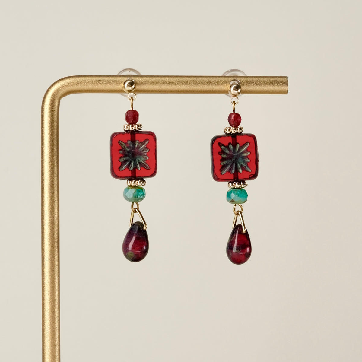 Red square Czech glass earrings with blue-green accents